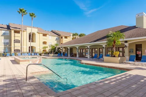 a front view of a house with swimming pool having outdoor seating