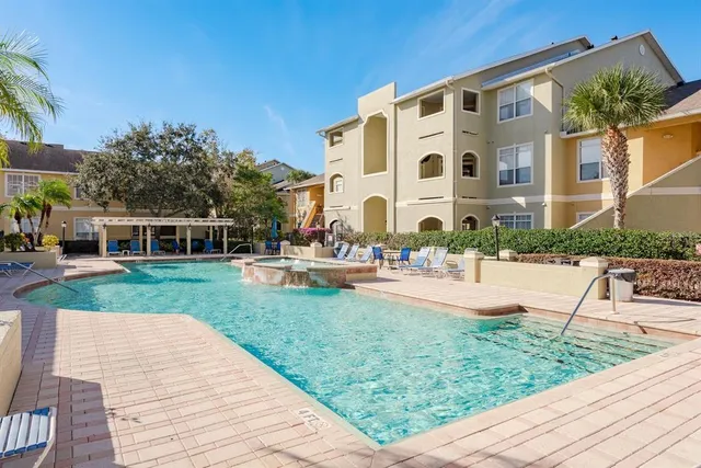 a view of a patio with a dining table and chairs with wooden floor