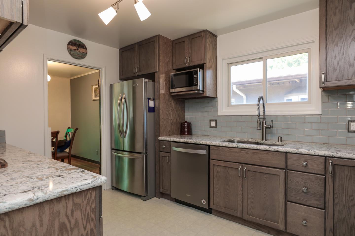 443 Dwight Road Burlingame, CA 94010 - Photo 10 of 28 a kitchen with stainless steel appliances granite countertop a sink stove and refrigerator