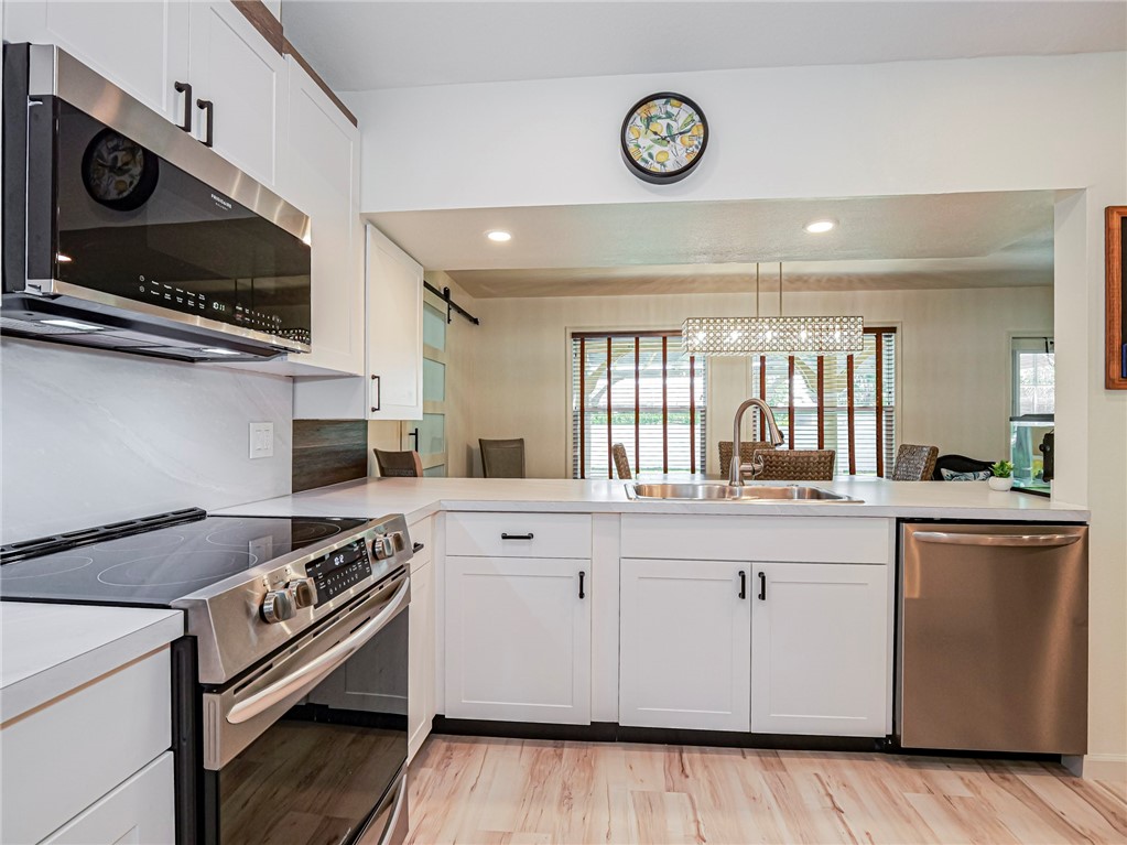 1732 Sunrise Lane Sebastian, FL 32958 - Photo 11 of 36 a kitchen with stainless steel appliances a sink a stove and cabinets