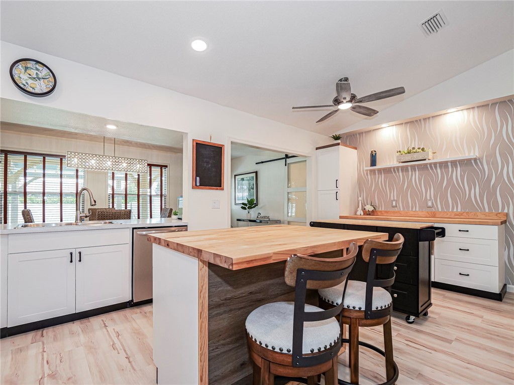 1732 Sunrise Lane Sebastian, FL 32958 - Photo 12 of 36 a kitchen with a table chairs stove and cabinets
