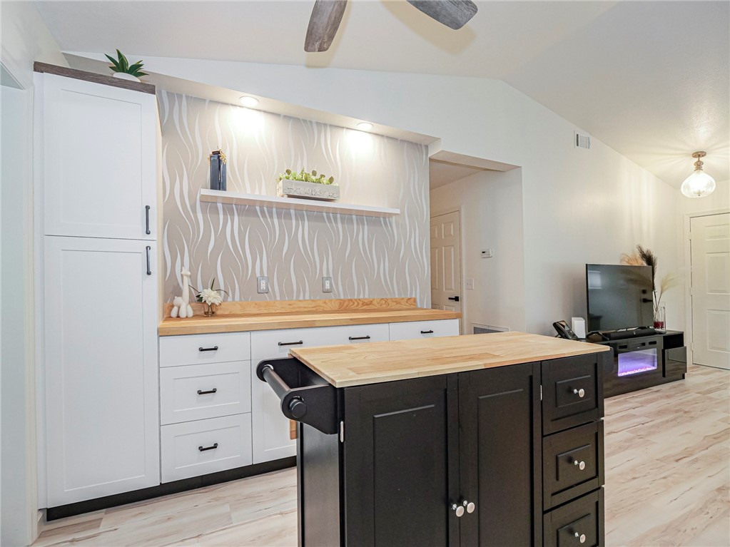 1732 Sunrise Lane Sebastian, FL 32958 - Photo 13 of 36 a kitchen with a sink dishwasher a stove and a refrigerator with wooden floor