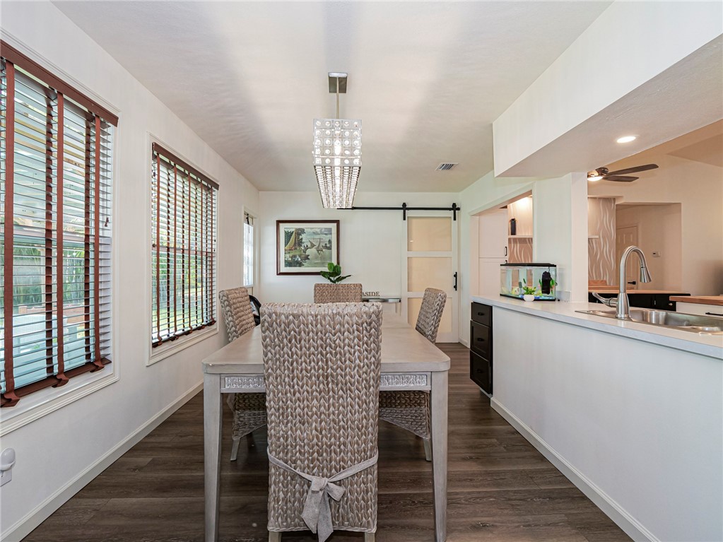 1732 Sunrise Lane Sebastian, FL 32958 - Photo 16 of 36 a view of a dining room with furniture window and wooden floor