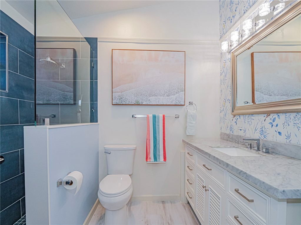 1732 Sunrise Lane Sebastian, FL 32958 - Photo 19 of 36 a bathroom with a granite countertop toilet sink and mirror