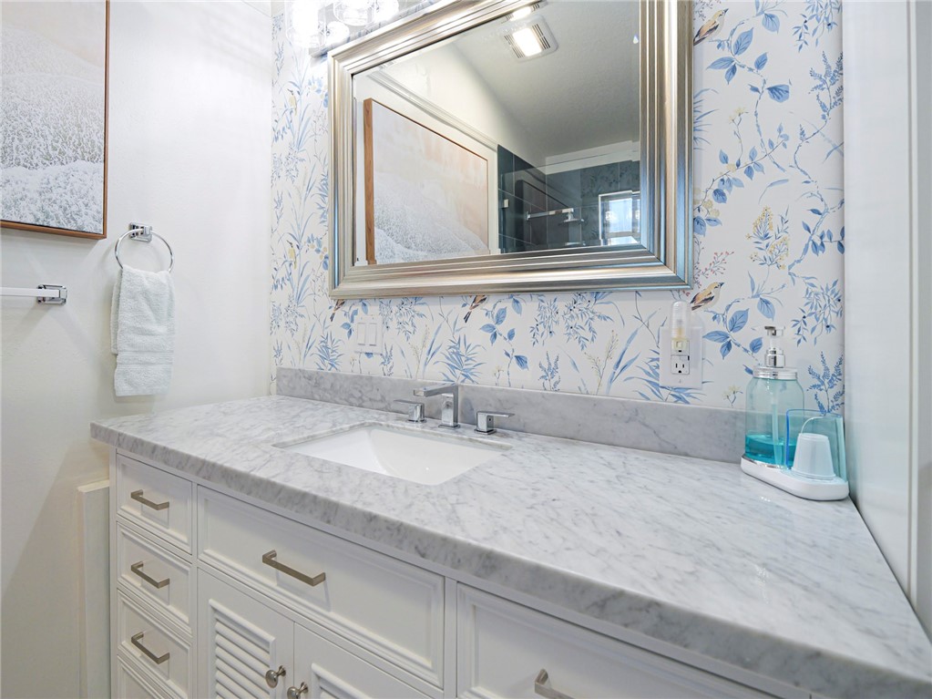 1732 Sunrise Lane Sebastian, FL 32958 - Photo 20 of 36 a bathroom with a granite countertop sink and a mirror