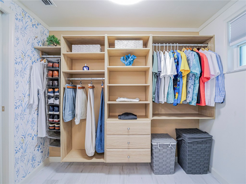 1732 Sunrise Lane Sebastian, FL 32958 - Photo 22 of 36 a view of walk in closet with clothes and shoes