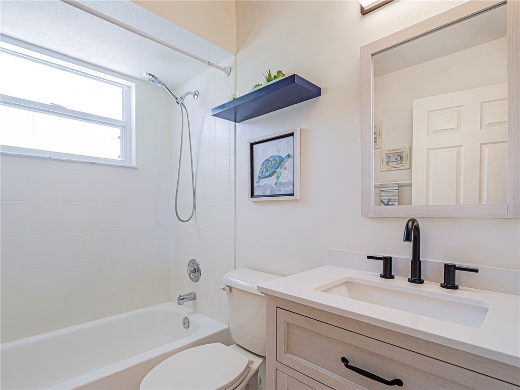 1732 Sunrise Lane Sebastian, FL 32958 - Photo 28 of 36 a bathroom with a sink a toilet and a bathtub