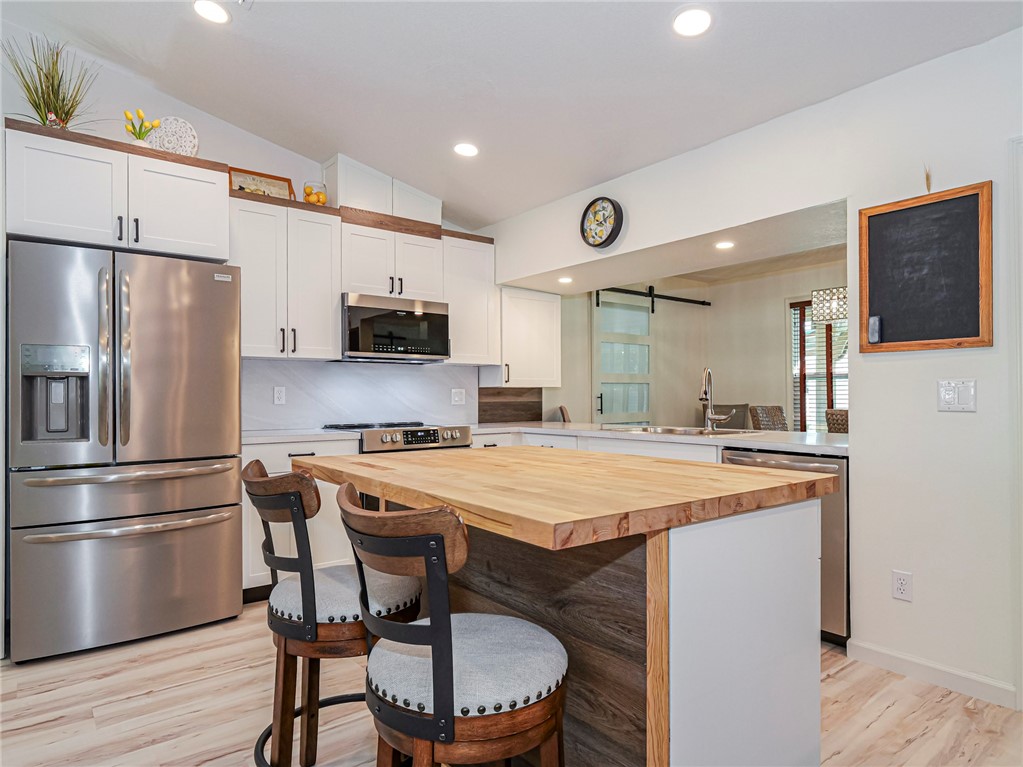 1732 Sunrise Lane Sebastian, FL 32958 - Photo 9 of 36 a kitchen with stainless steel appliances a stove a sink and a refrigerator