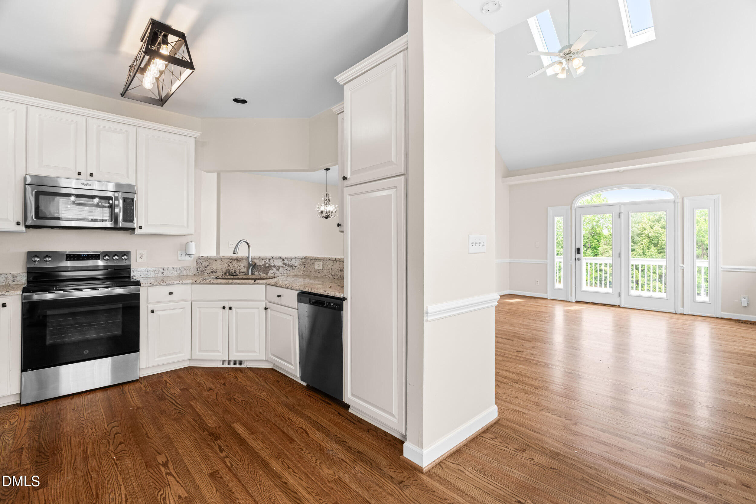 744 Seastone Street Raleigh, NC 27603 - Photo 21 of 53 a kitchen with granite countertop a refrigerator stove top oven and sink