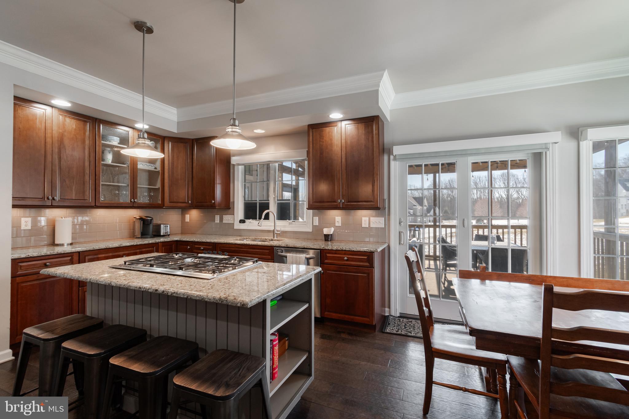 12911 Buckeye Drive North Potomac, MD 20878 - Photo 13 of 74 a kitchen with a stove a table and chairs in it