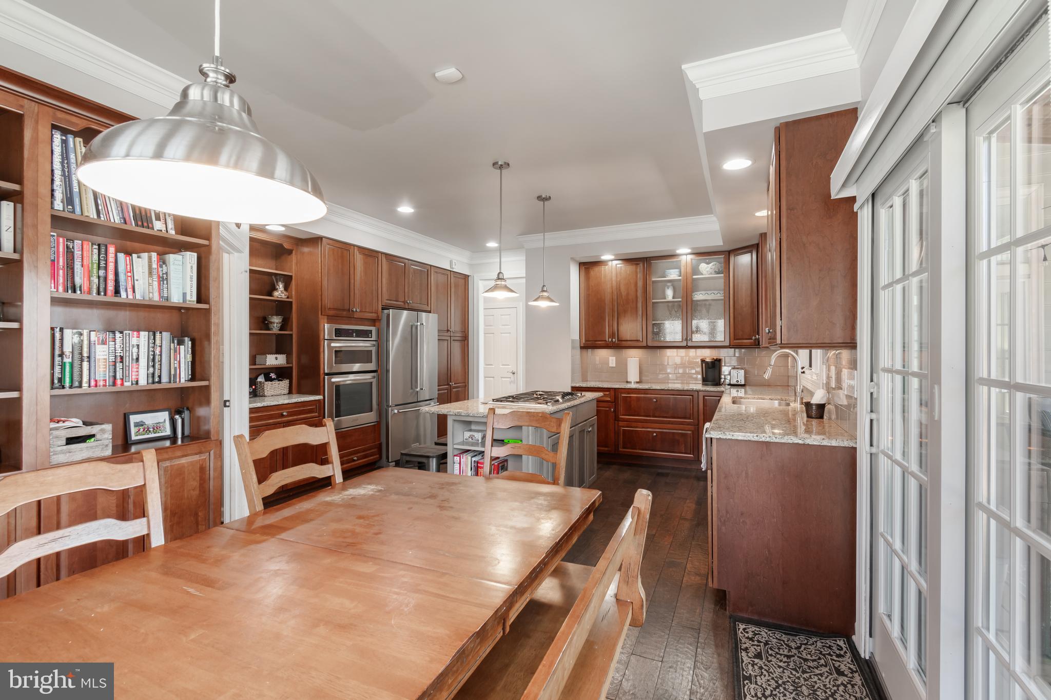 12911 Buckeye Drive North Potomac, MD 20878 - Photo 23 of 74 a kitchen with stainless steel appliances kitchen island granite countertop a refrigerator and a stove top oven