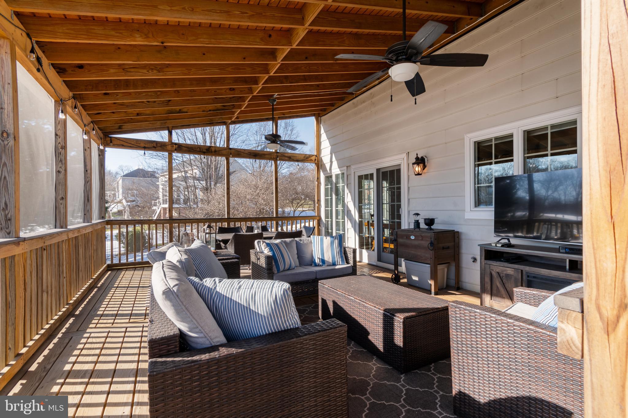 12911 Buckeye Drive North Potomac, MD 20878 - Photo 27 of 74 a living room with patio furniture and a flat screen tv