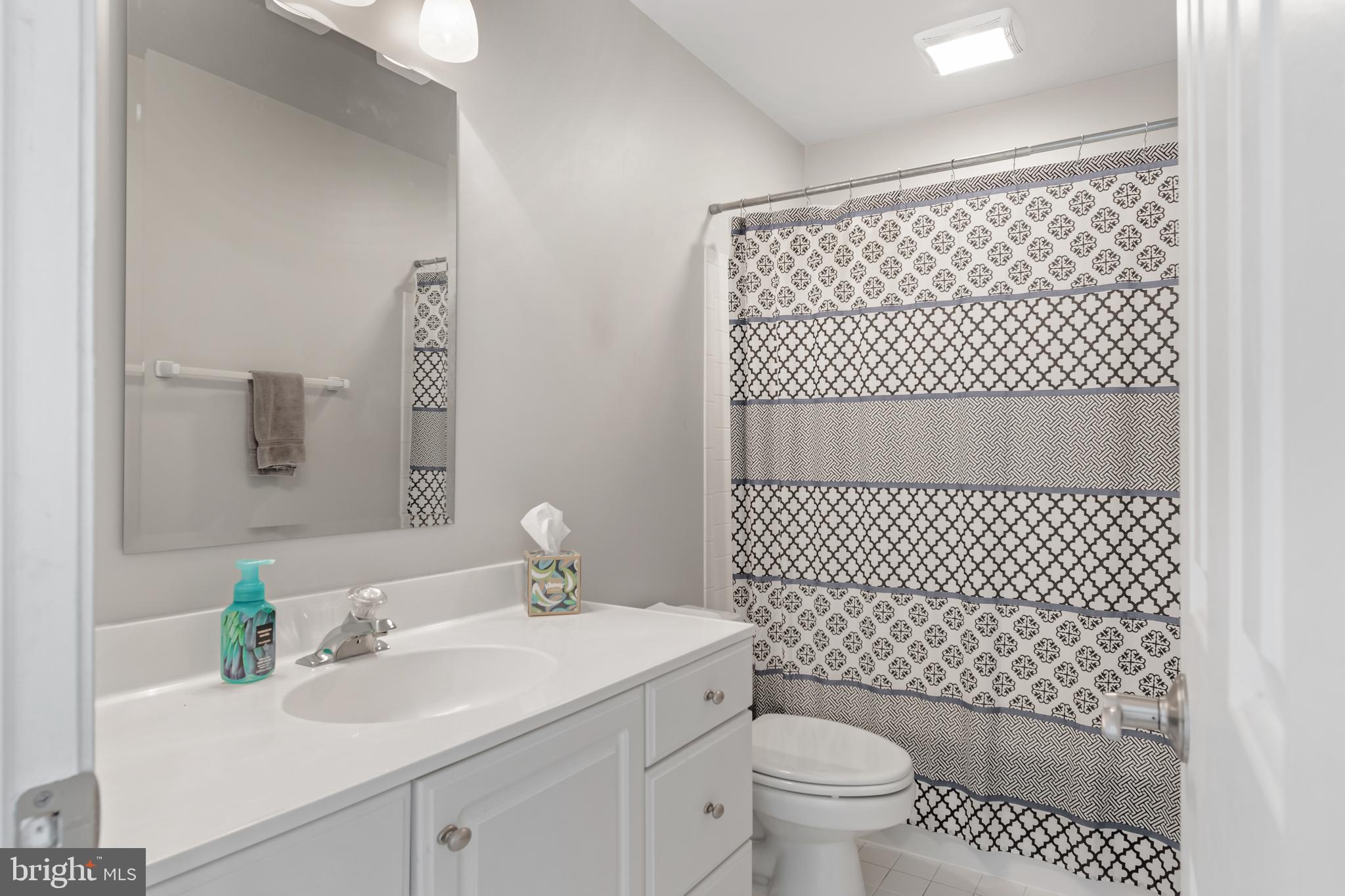 12911 Buckeye Drive North Potomac, MD 20878 - Photo 55 of 74 a bathroom with a sink toilet and a mirror