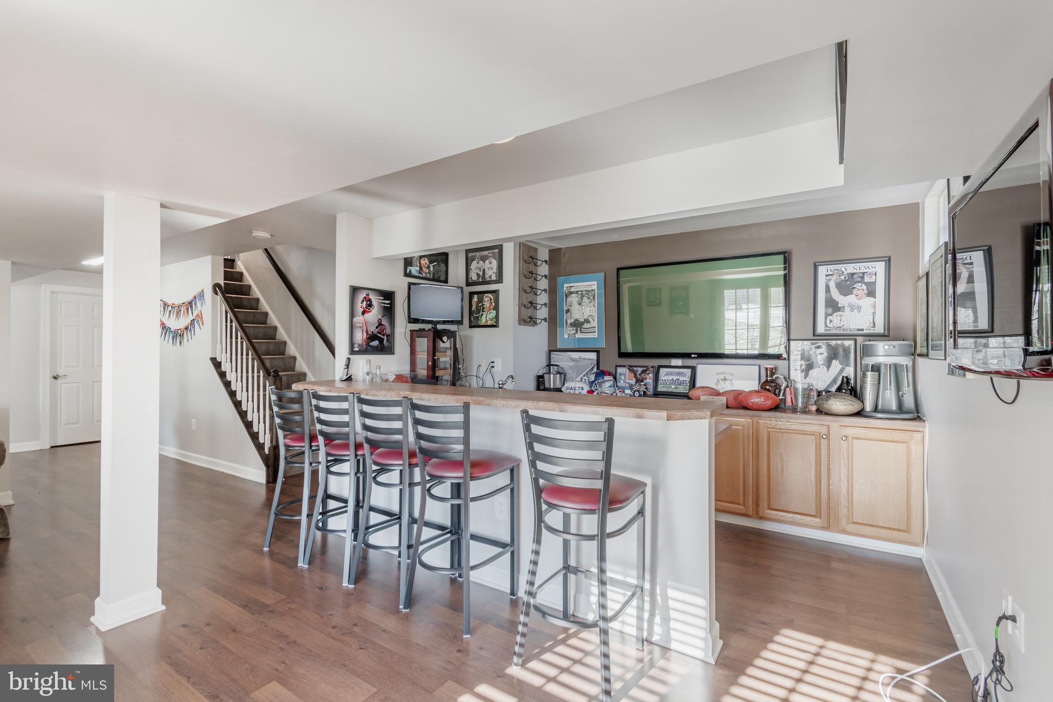 12911 Buckeye Drive North Potomac, MD 20878 - Photo 59 of 74 a kitchen with a dining table chairs and white cabinets