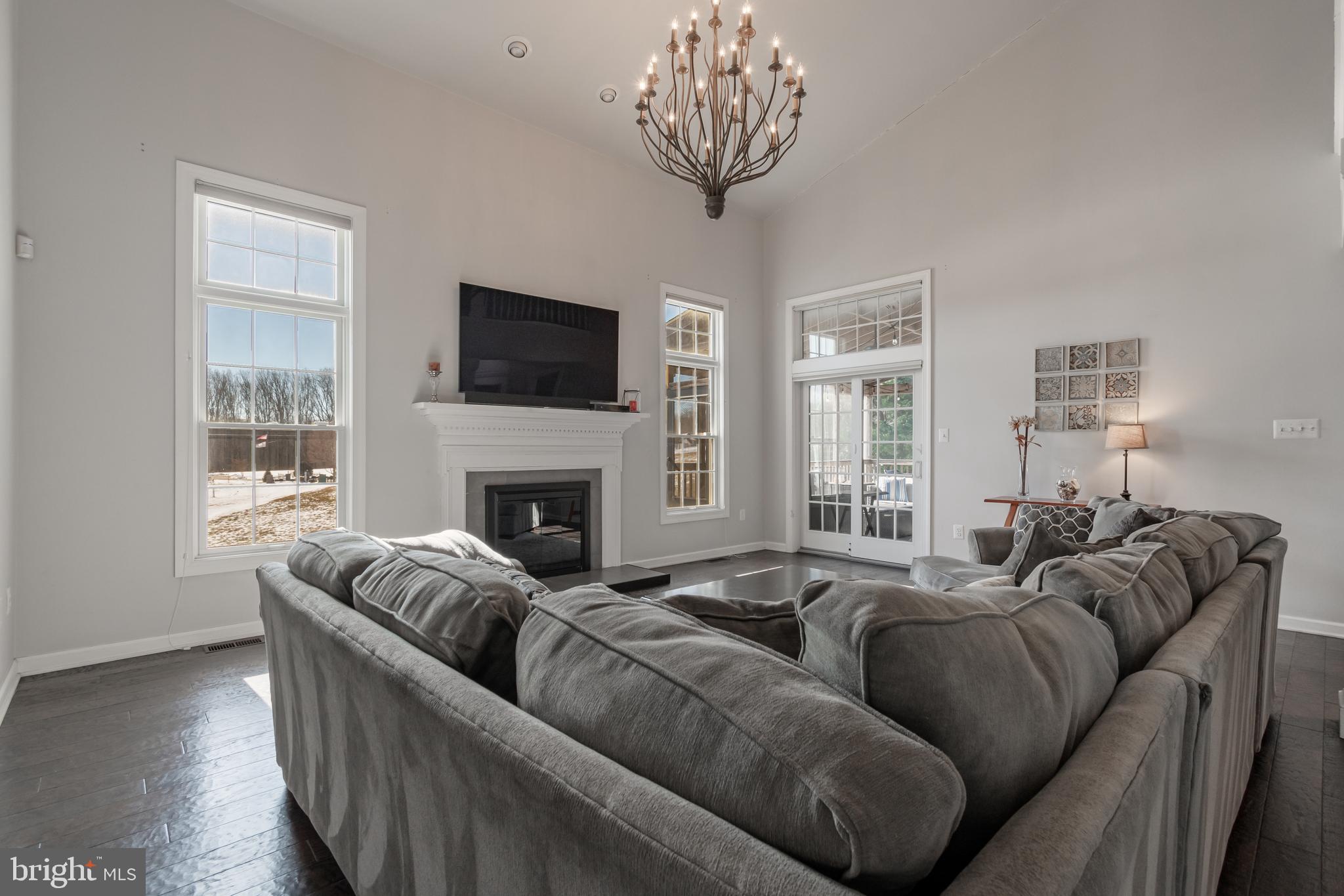 12911 Buckeye Drive North Potomac, MD 20878 - Photo 6 of 74 a living room with furniture a flat screen tv and a fireplace