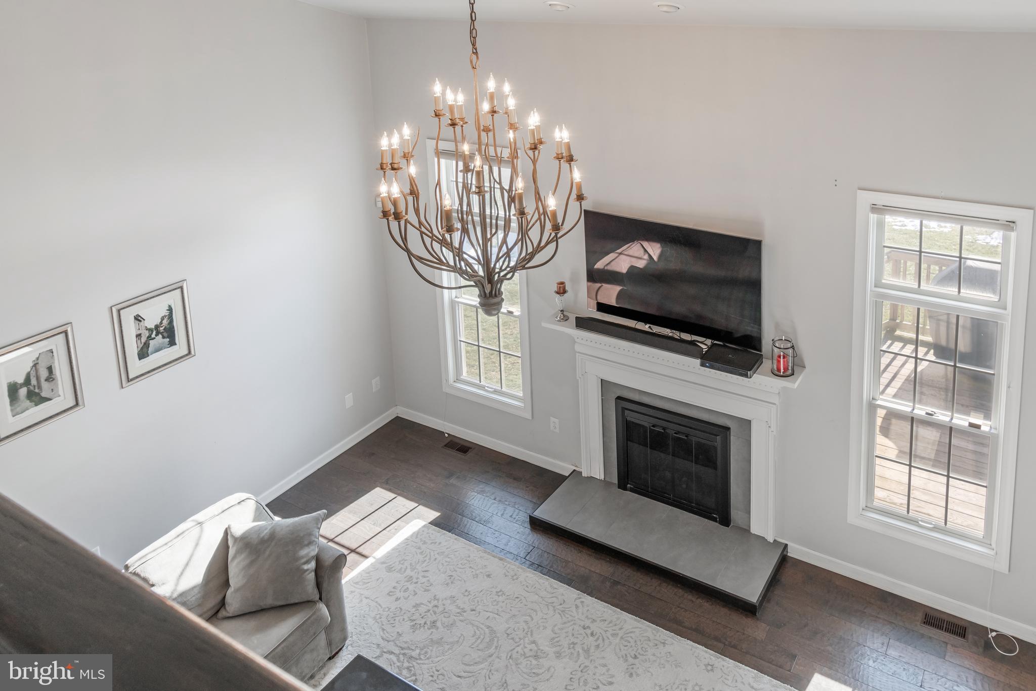 12911 Buckeye Drive North Potomac, MD 20878 - Photo 10 of 74 a living room with furniture a flat screen tv and a fireplace