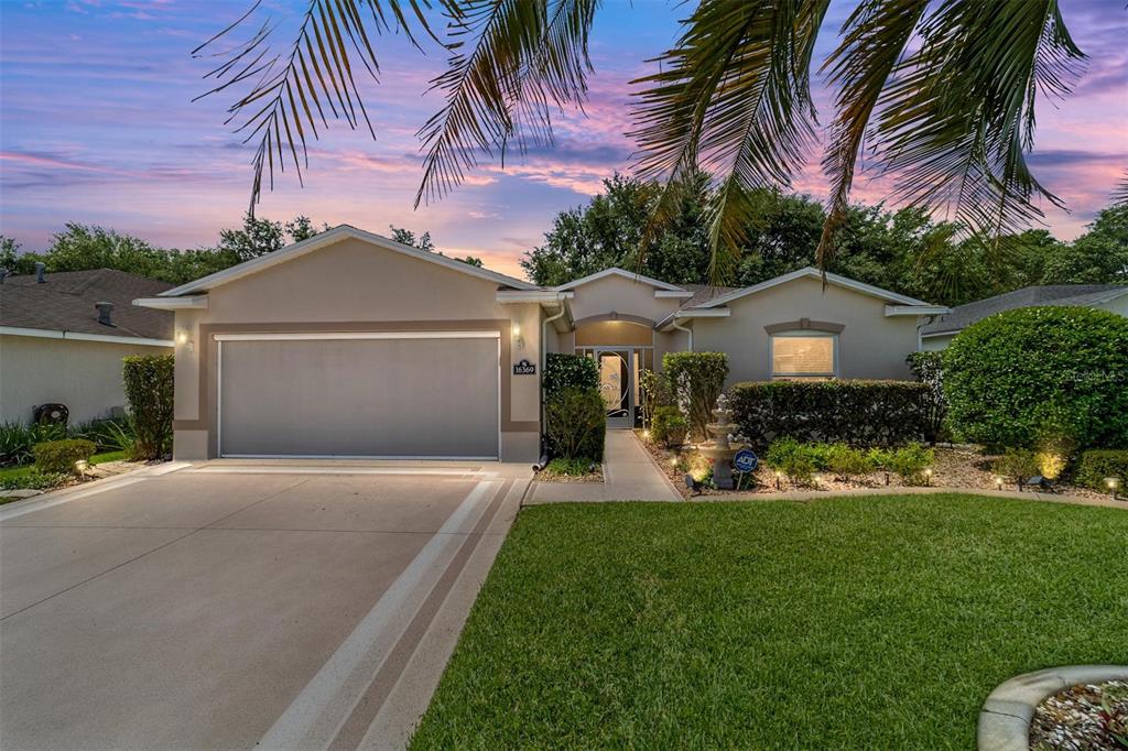 16369 Southwest 14th Avenue Road Ocala, FL 34473 - Photo 1 of 49 a front view of a house with a garden and yard