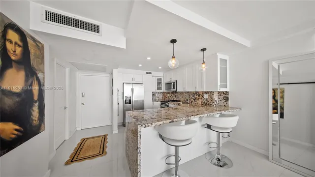 a large kitchen with a refrigerator a sink and a stove