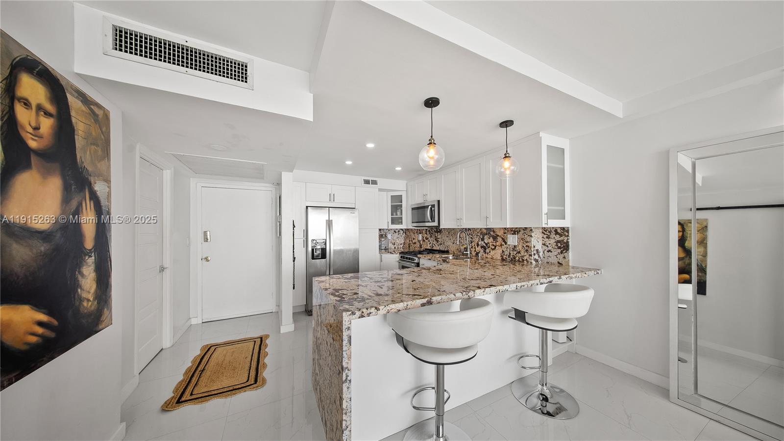 2030 South Ocean Drive, Unit 1716 Hallandale Beach, FL 33009 - Photo 8 of 15 a large kitchen with a refrigerator a sink and a stove