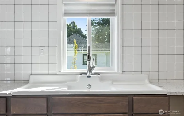 a kitchen with stainless steel appliances a stove sink and cabinets