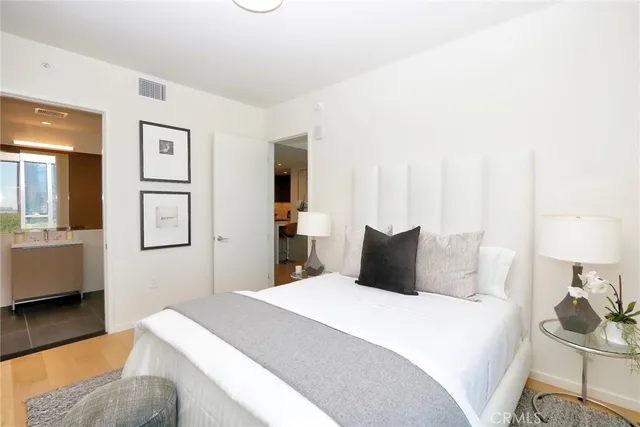 a bedroom with a bed and wooden floor