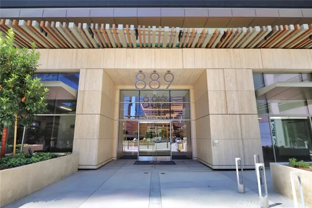 a living room with furniture large windows and view of lake