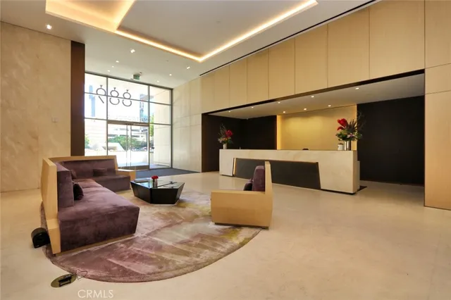 a living room with furniture and large windows