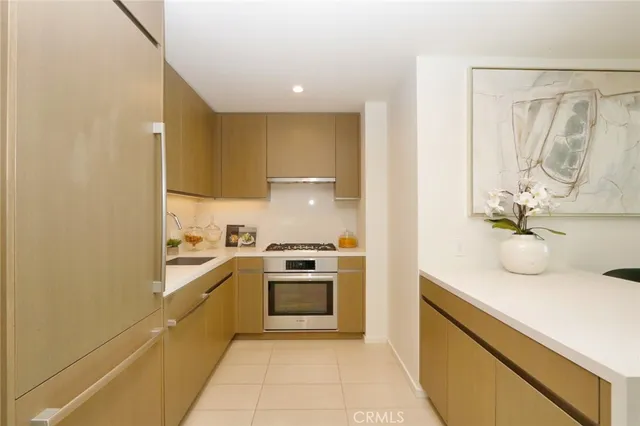 a kitchen with a sink and stove top oven
