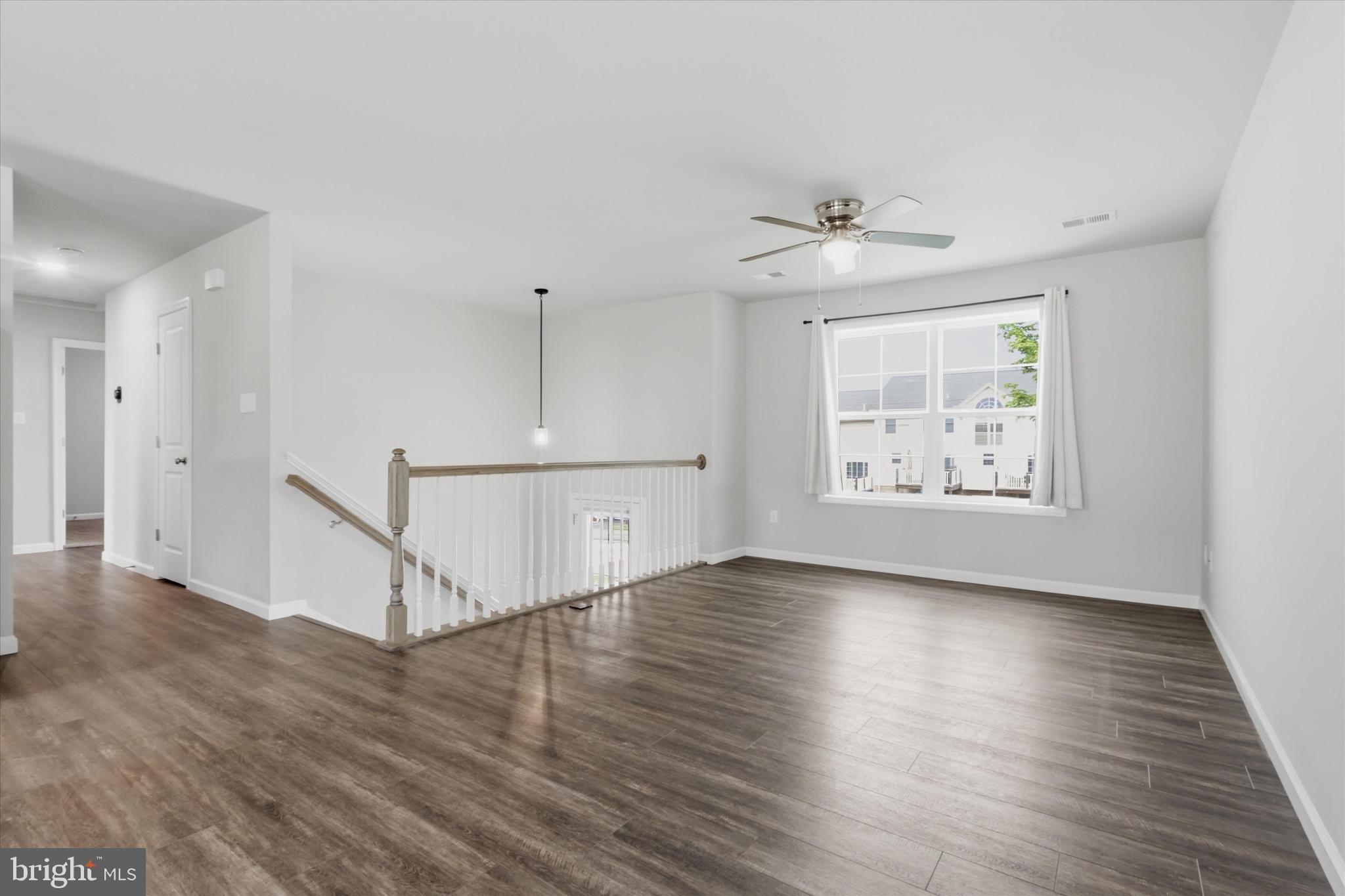 338 Grandview Avenue Waynesboro, PA 17268 - Photo 5 of 40 an empty room with wooden floor chandelier fan and windows