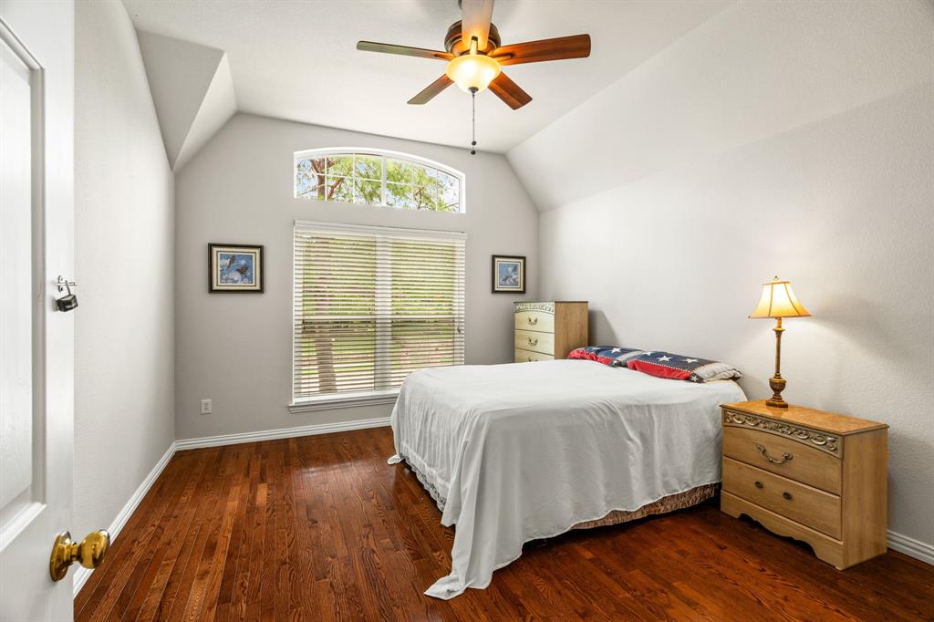 2012 Burnside Drive Allen, TX 75013 - Photo 17 of 40 a bedroom with a bed and a chandelier