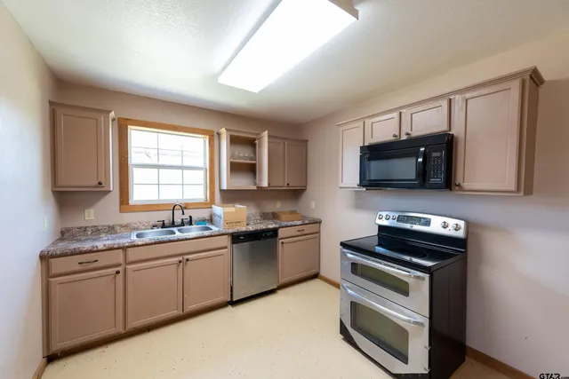 a kitchen with a table chairs and microwave