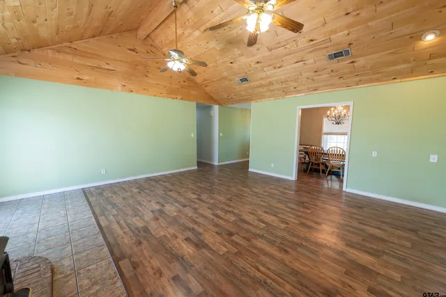 a view of a room with wooden floor