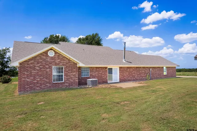 a view of a house with a yard and garage