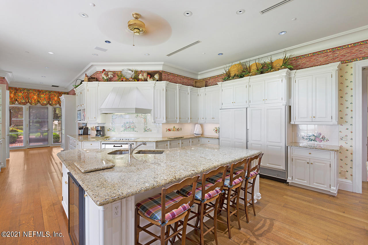 2180 Eventide Avenue St. Johns, FL 32259 - Photo 66 of 91 a kitchen with a stove a refrigerator a sink and dishwasher with wooden floor