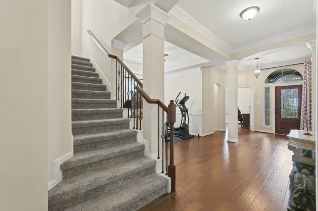a view of entryway and hall with wooden floor