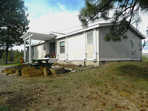 a view of a house with a yard and sitting area