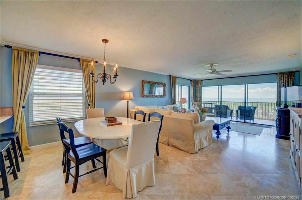 2491 Northeast Ocean Boulevard, Unit 103 Stuart, FL 34996 - Photo 11 of 38 a dining room with furniture and wooden floor
