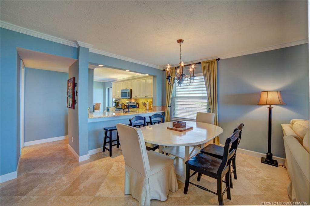 2491 Northeast Ocean Boulevard, Unit 103 Stuart, FL 34996 - Photo 14 of 38 a view of a dining room with furniture and wooden floor