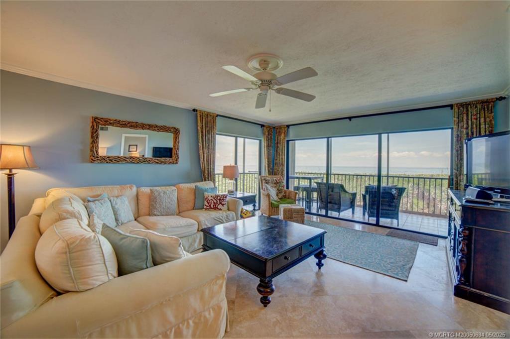 2491 Northeast Ocean Boulevard, Unit 103 Stuart, FL 34996 - Photo 15 of 38 a living room with furniture and a large window