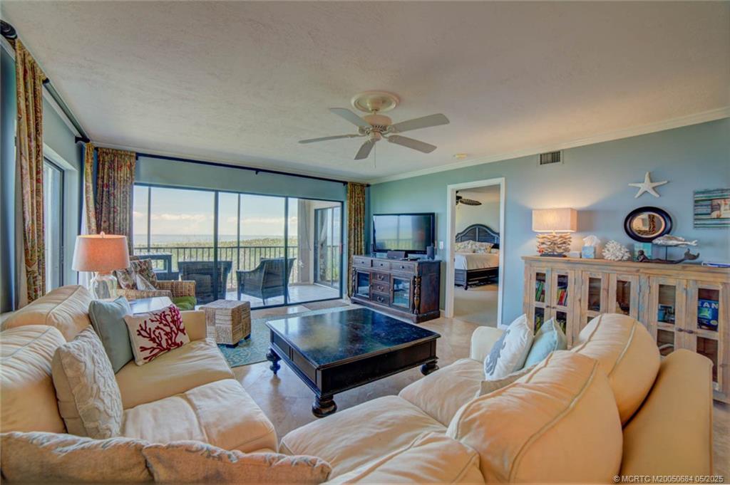 2491 Northeast Ocean Boulevard, Unit 103 Stuart, FL 34996 - Photo 16 of 38 a living room with furniture and a large window