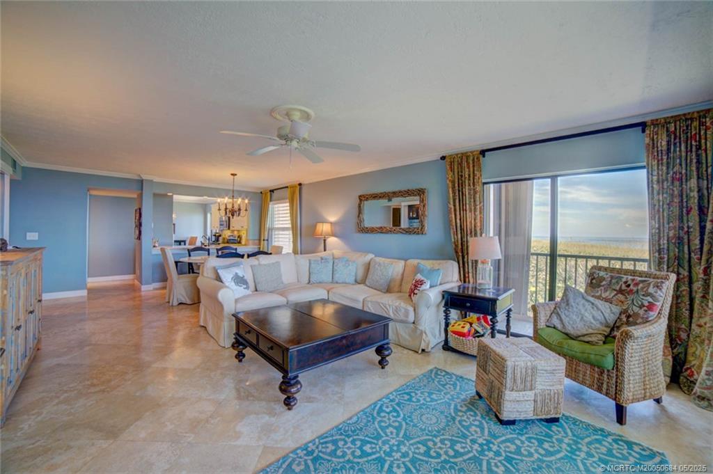 2491 Northeast Ocean Boulevard, Unit 103 Stuart, FL 34996 - Photo 18 of 38 a living room with furniture and a large window