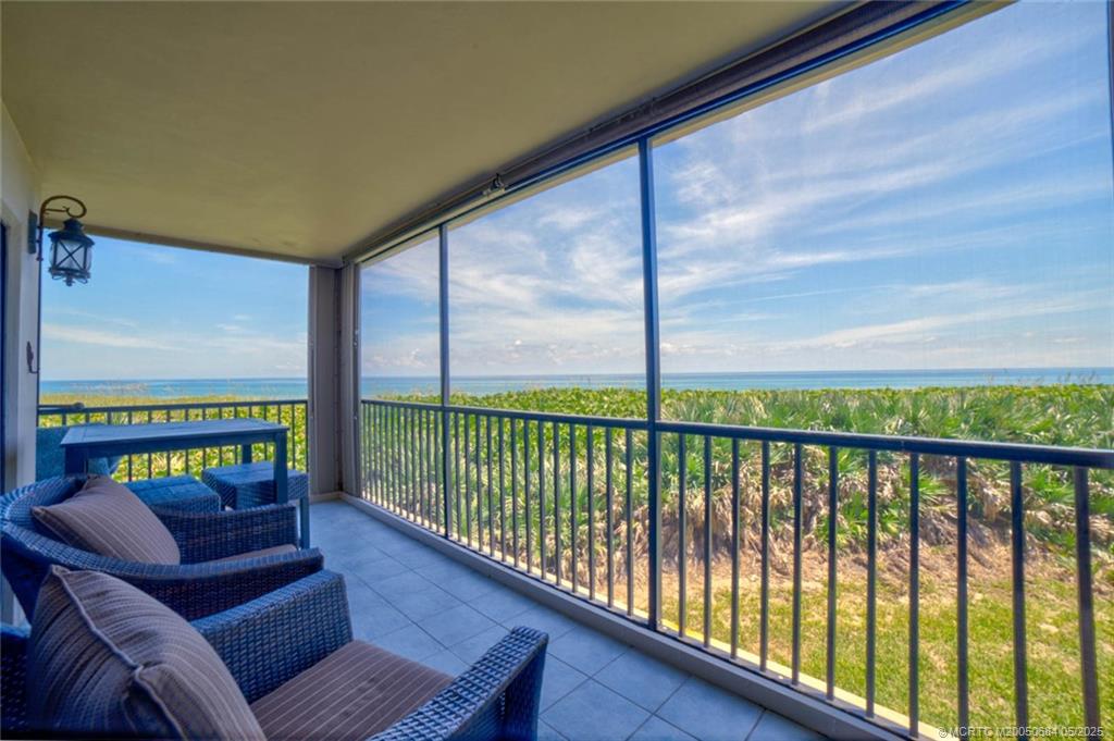 2491 Northeast Ocean Boulevard, Unit 103 Stuart, FL 34996 - Photo 2 of 38 a balcony with furniture