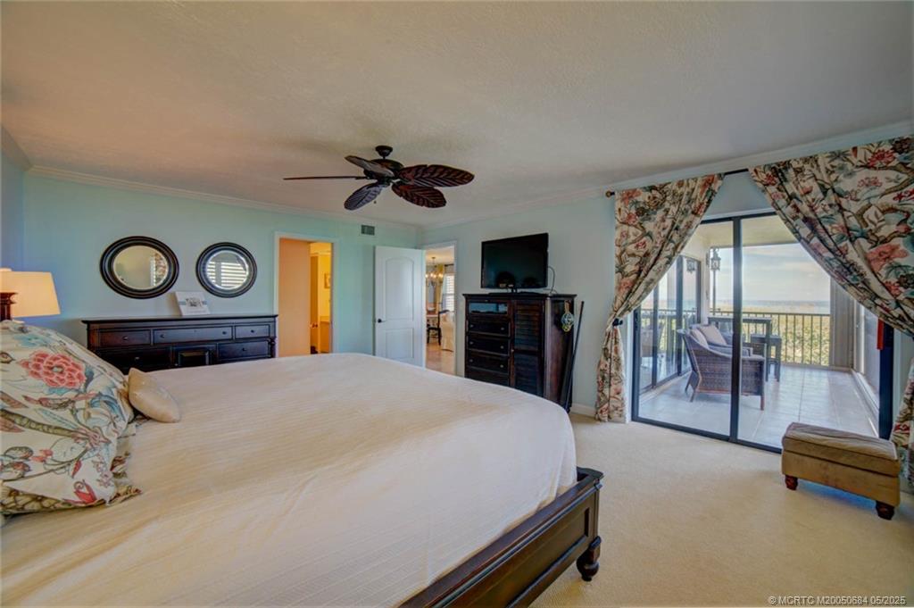 2491 Northeast Ocean Boulevard, Unit 103 Stuart, FL 34996 - Photo 21 of 38 a bedroom with a bed and a flat tv screen on dresser