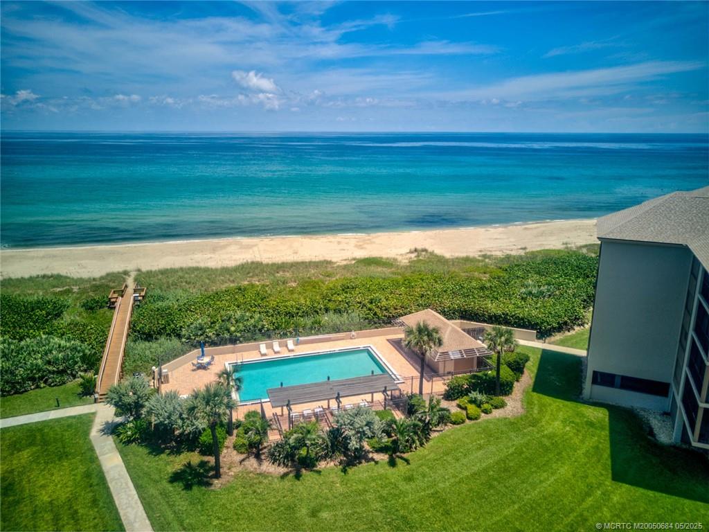2491 Northeast Ocean Boulevard, Unit 103 Stuart, FL 34996 - Photo 31 of 38 a view of a chairs in a big yard with potted plants