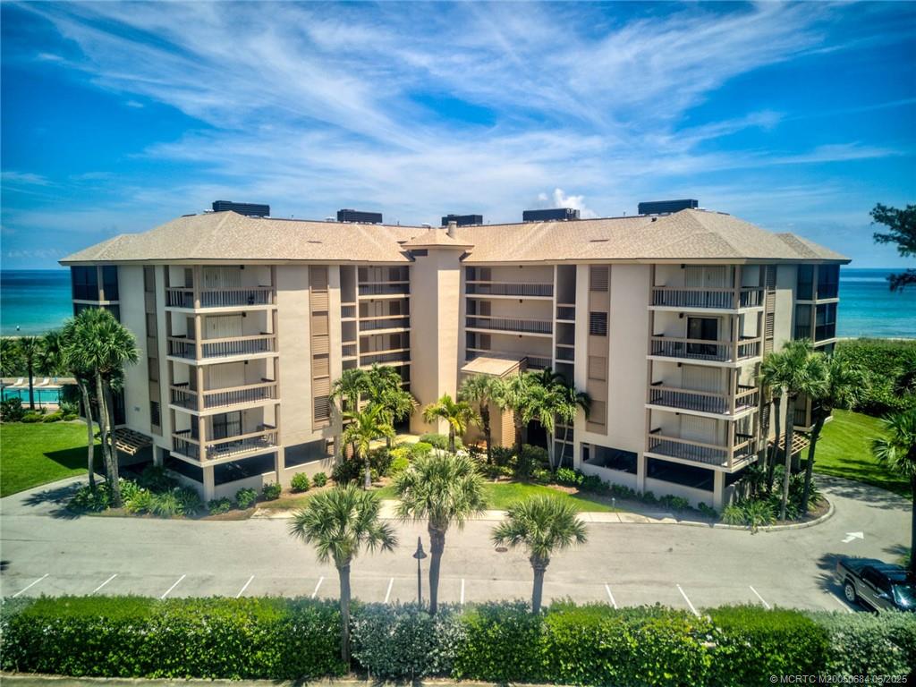 2491 Northeast Ocean Boulevard, Unit 103 Stuart, FL 34996 - Photo 33 of 38 a front view of a house with a garden