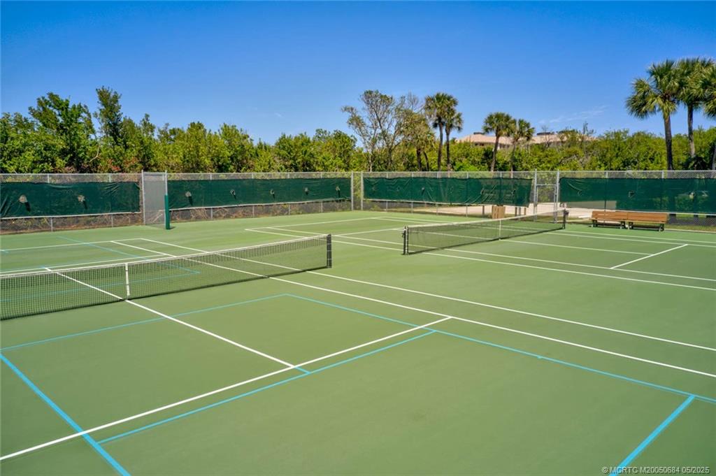 2491 Northeast Ocean Boulevard, Unit 103 Stuart, FL 34996 - Photo 37 of 38 a view of an outdoor space and tennis court