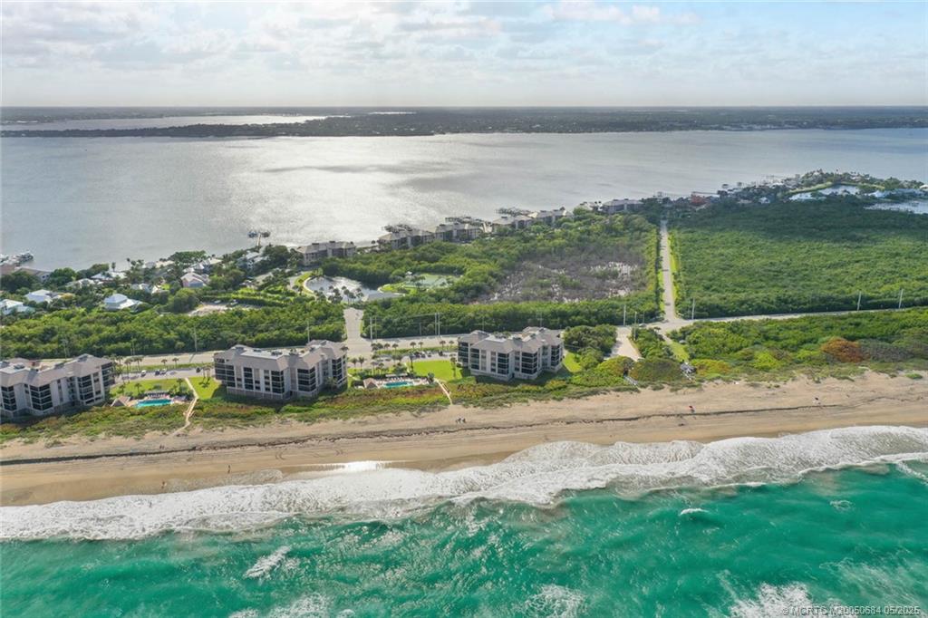 2491 Northeast Ocean Boulevard, Unit 103 Stuart, FL 34996 - Photo 38 of 38 a view of a lake with a houses in the back