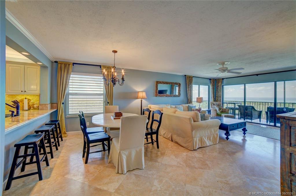 2491 Northeast Ocean Boulevard, Unit 103 Stuart, FL 34996 - Photo 7 of 38 a living room with furniture and a large window