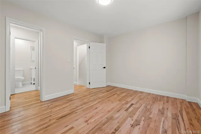 a view of an empty room and wooden floor