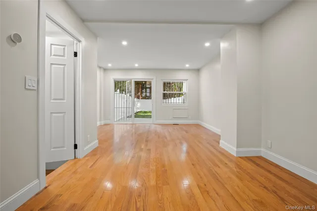 a view of a livingroom with wooden floor and a window